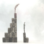 Inequality concept - one person on a taller pile of stones than the other